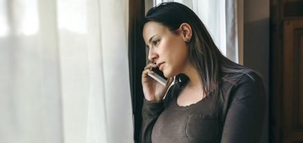 24-7MedCare Woman talking on phone and looking out of window