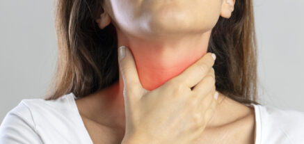 Woman diagnosed with Tonsillitis exhibiting sore throat symptoms.